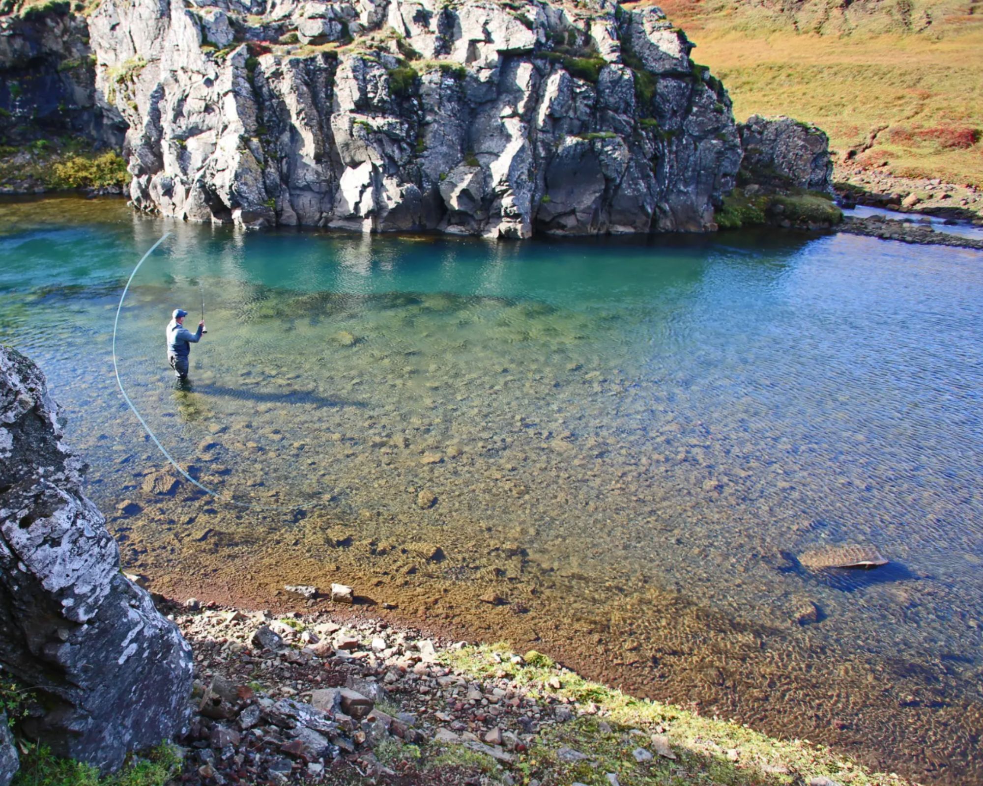 Tranquil moments on the water, fishing in Iceland’s pristine lakes, where luxury meets the wild in peaceful harmony.
